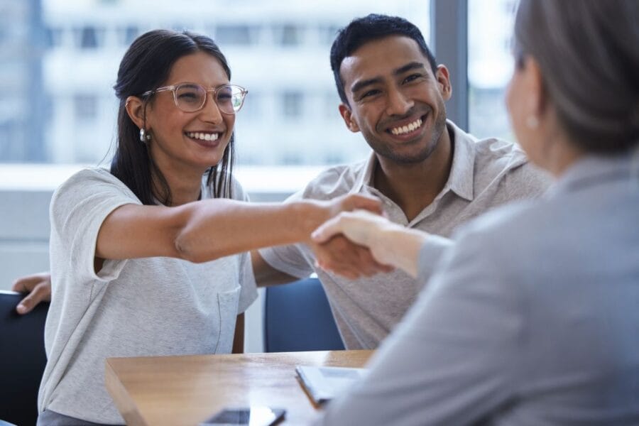 Young couple meets with a loan advisor to get approved for a coffee shop loan