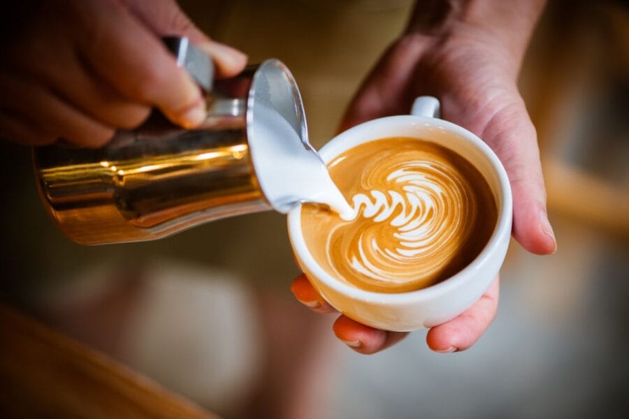 A person creating latte art.