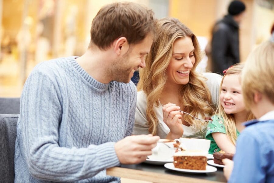 Family Enjoying Snack In Cafe